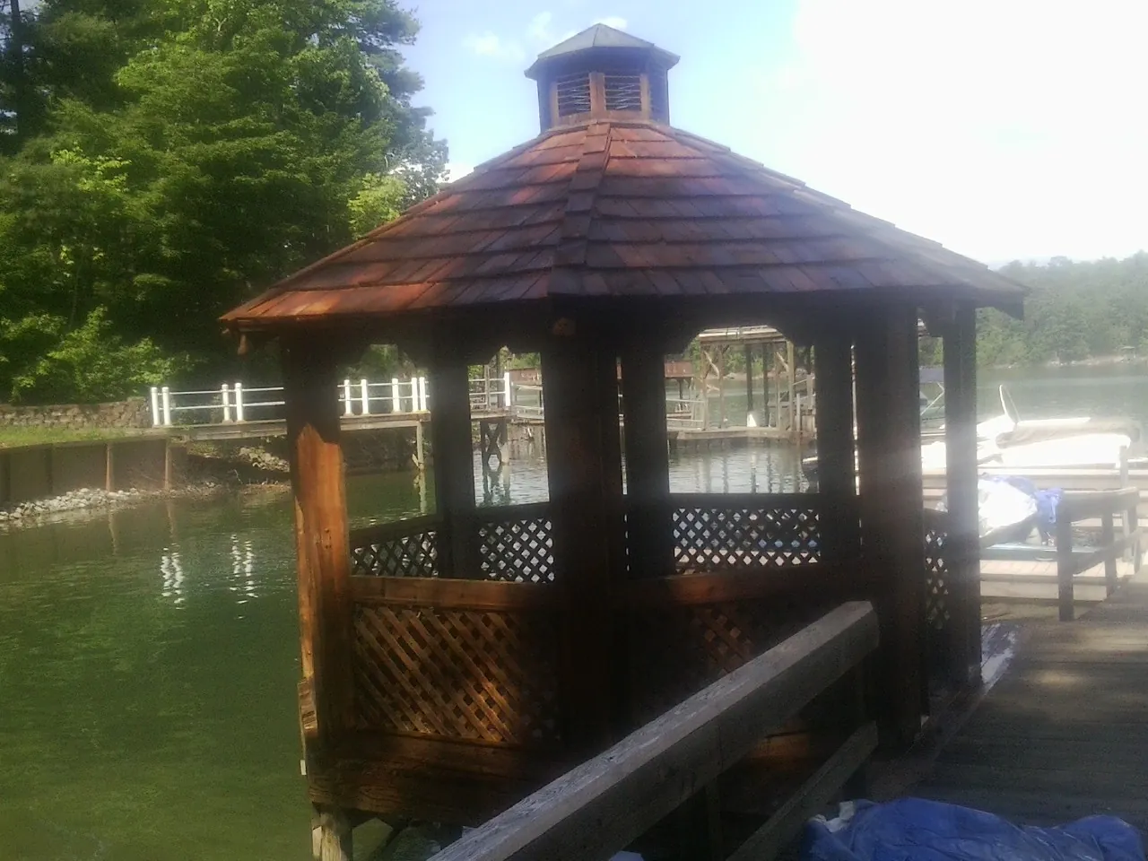 Cedar shake gazebo roof rebuilt on a lake dock in Harvard